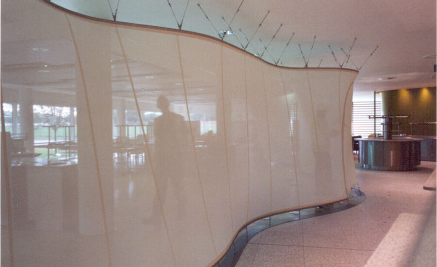 Staff restaurant seating beside the curved glass mesh screen at BT Leavesden Park