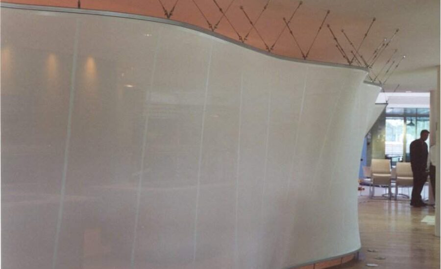 Glass mesh fabric screen separating kitchen and seating in the BT Leavesden Park staff restaurant