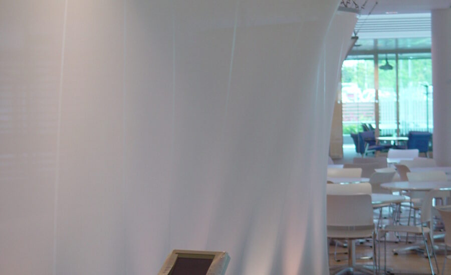 Curved glass mesh fabric screen dividing the BT staff restaurant at Leavesden Park, overview