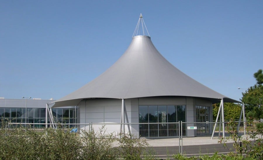 Fabric structure over a building