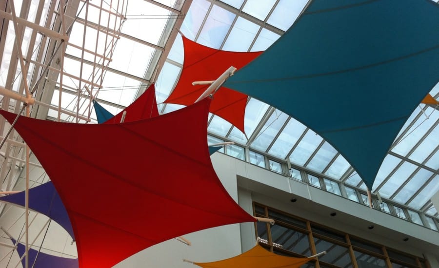 Kite shaped fabric sun shades for office building