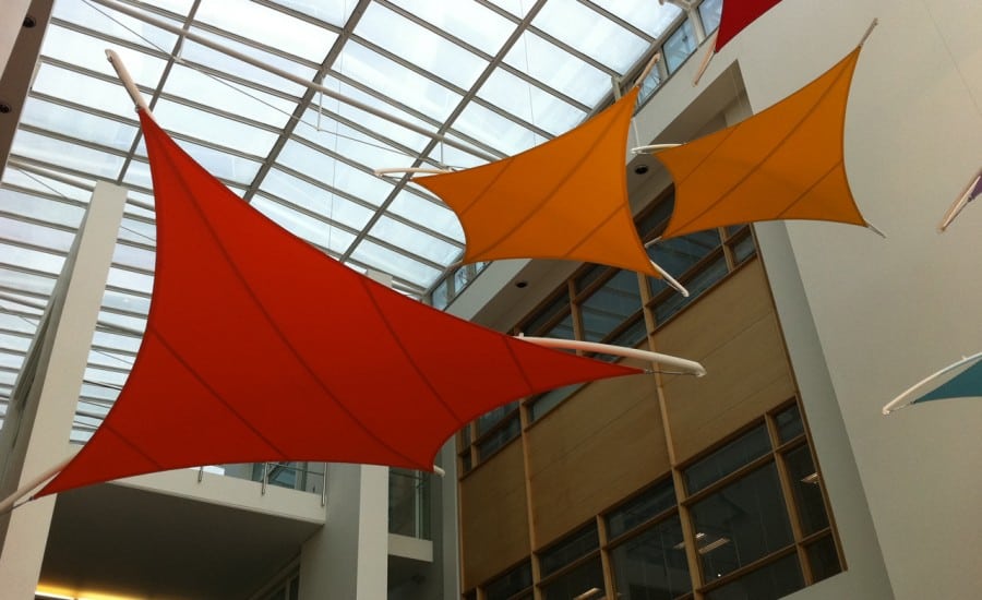 Coloured tensile fabric shades in office