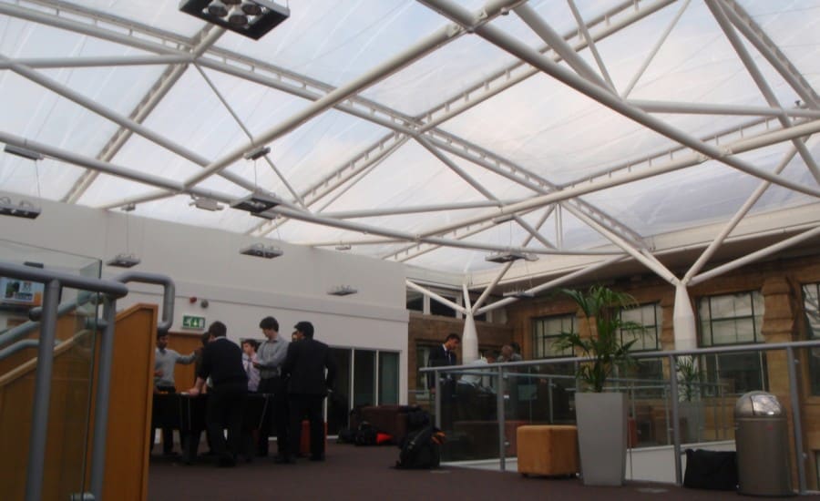 Light transmitting fabric roof over school buildings