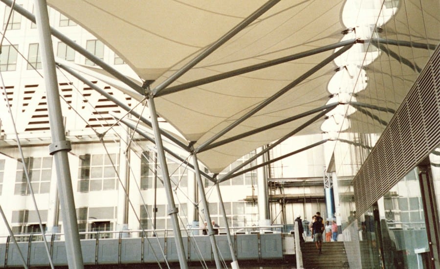 Wind deflecting fabric canopy