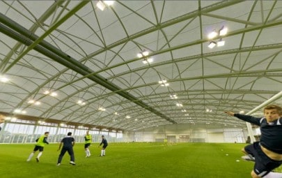 Tensile fabric roof over a football pitch