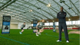 Fabric roof structure over sports training ground