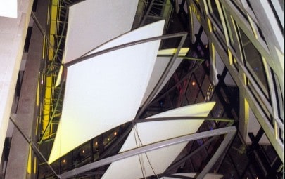 Internal floating fabric panels in atrium